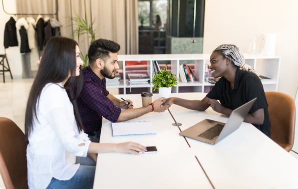 service rep practicing customer intimacy shaking hands with clients